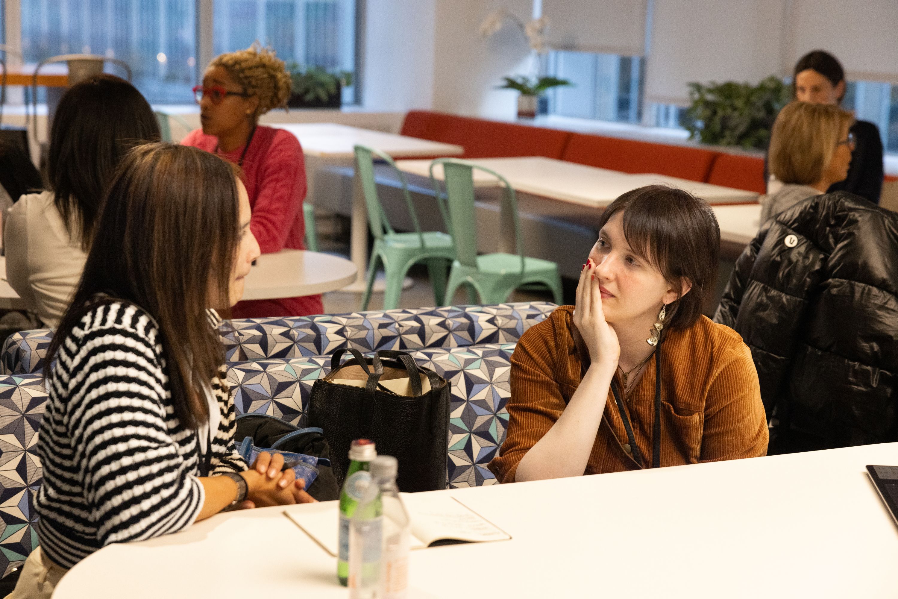 Emma listening to a team member at a workshop table